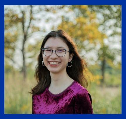 A picture of a woman with black hair and a purple shirt